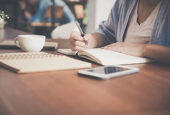 man writing in a notebook